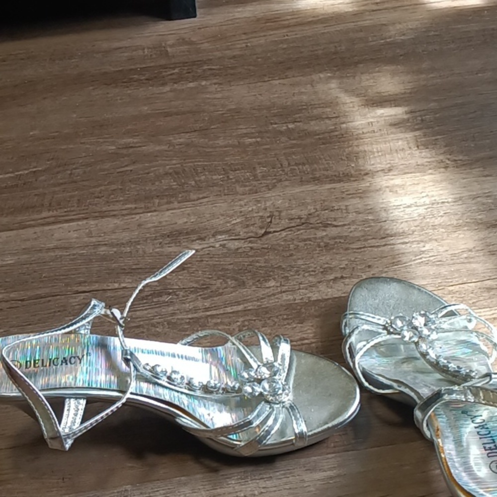 A silver glass shoe with beads and a butterfly